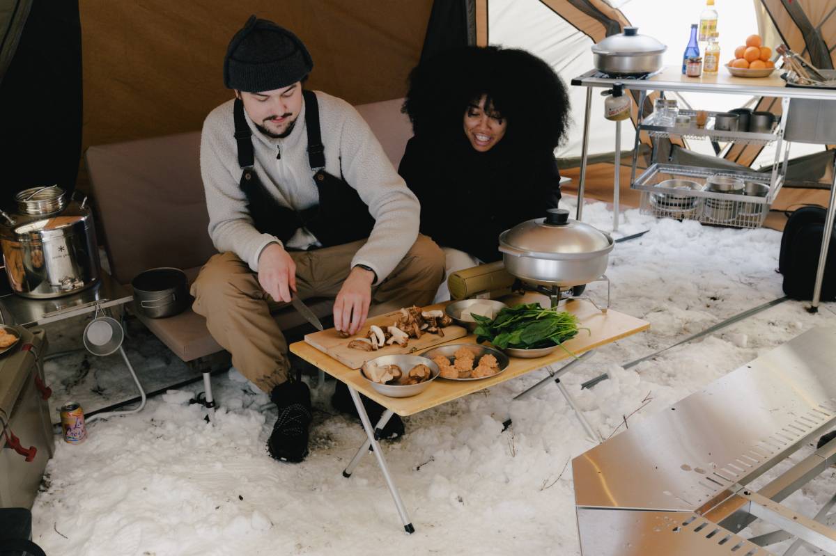 couple cooking dinner outdoor camping